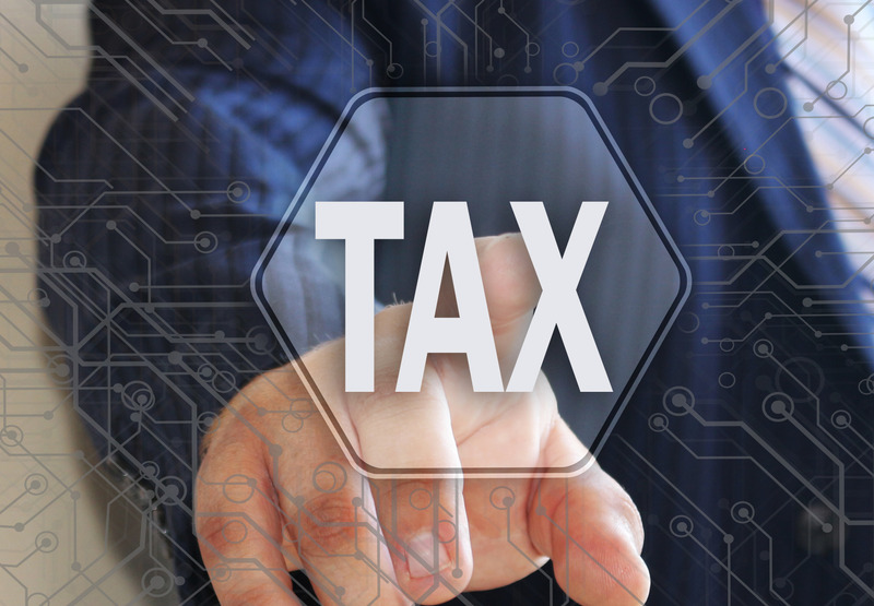 E-Filing Tax concept. The businessman chooses the TAX on a touch screen. Template TAX.